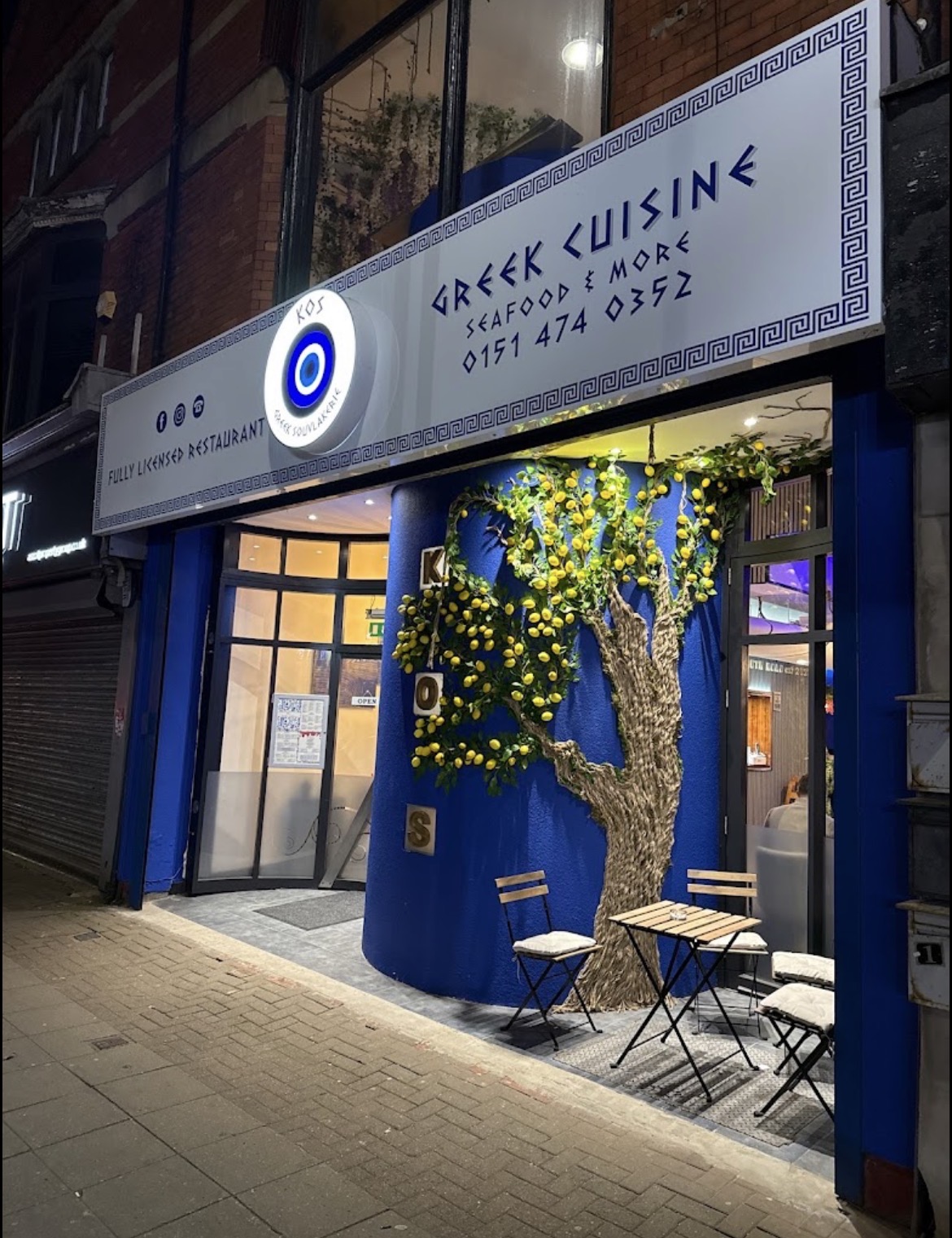 The blue entrance to KOS Greek Restaurant at night